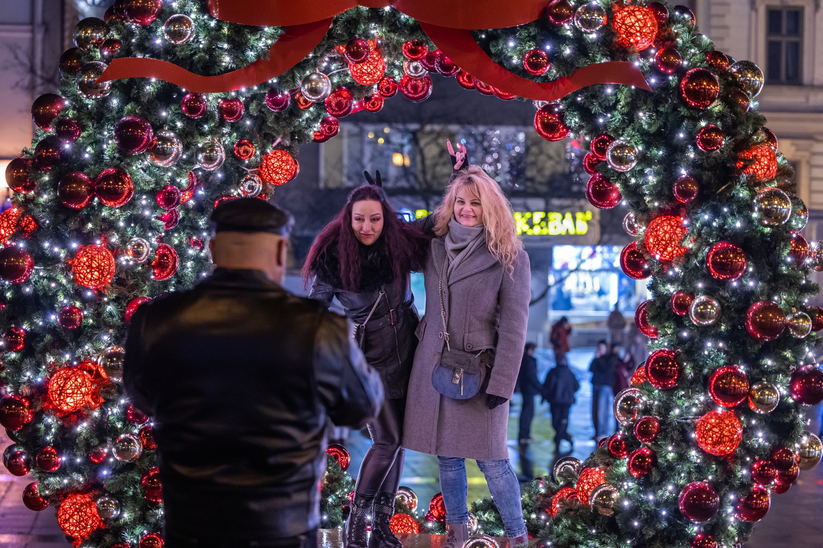 na zdjęciu ozdobione miasto i osoby podczas rozświetlenia
