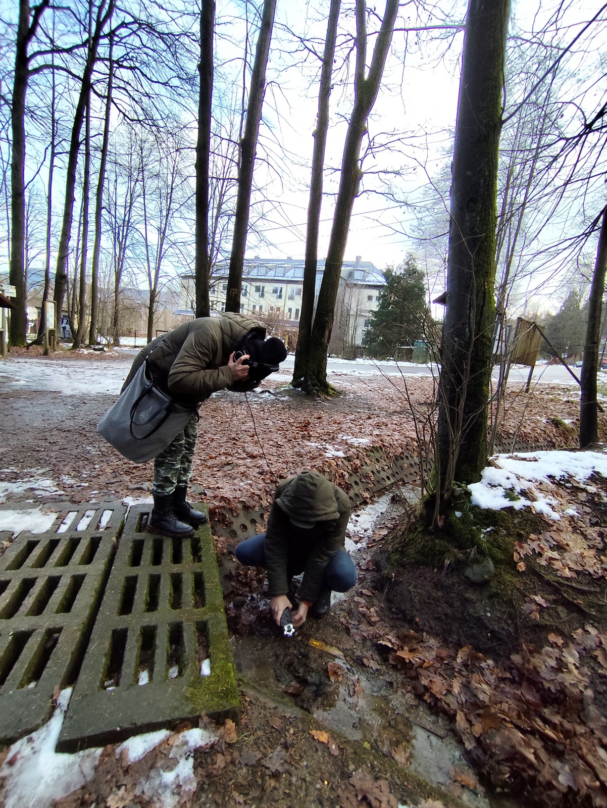 Person wearing headphones, listening to the recorded sound of a forest stream.