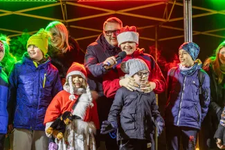 na zdjęciu ozdobione miasto i osoby podczas rozświetlenia