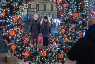 na zdjęciu ozdobione miasto i osoby podczas rozświetlenia