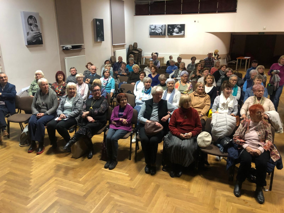 Na zdjęciu siedzący ludzie 