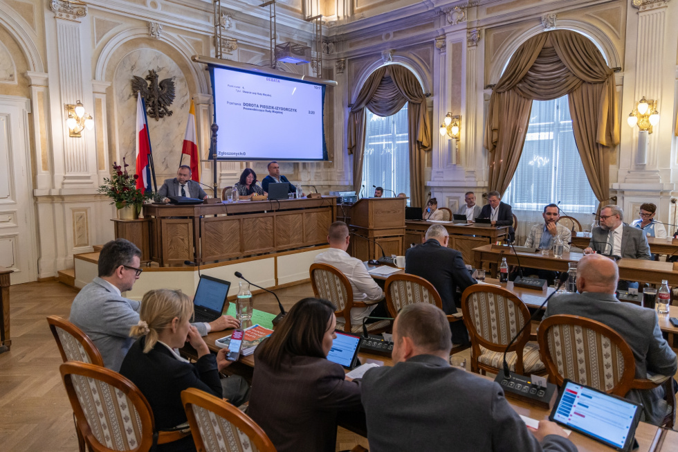 Na zdjęciu siedzący ludzie 