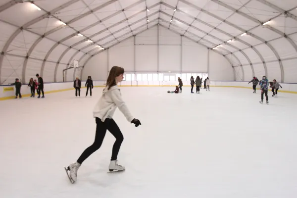Na zdjęciu stojący ludzie 