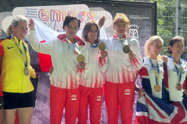 Na zdjęciu stojący ludzie 