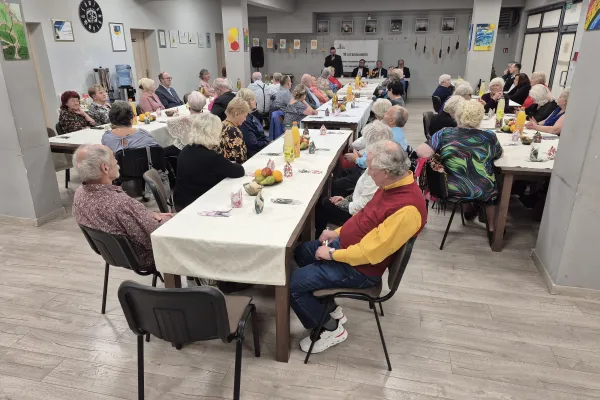 Na zdjęciu siedzący ludzie 