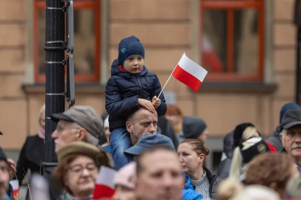 Na zdjęciu dziecko z flagą w dłoni, uczestnicy niepodległościowych uroczystości 